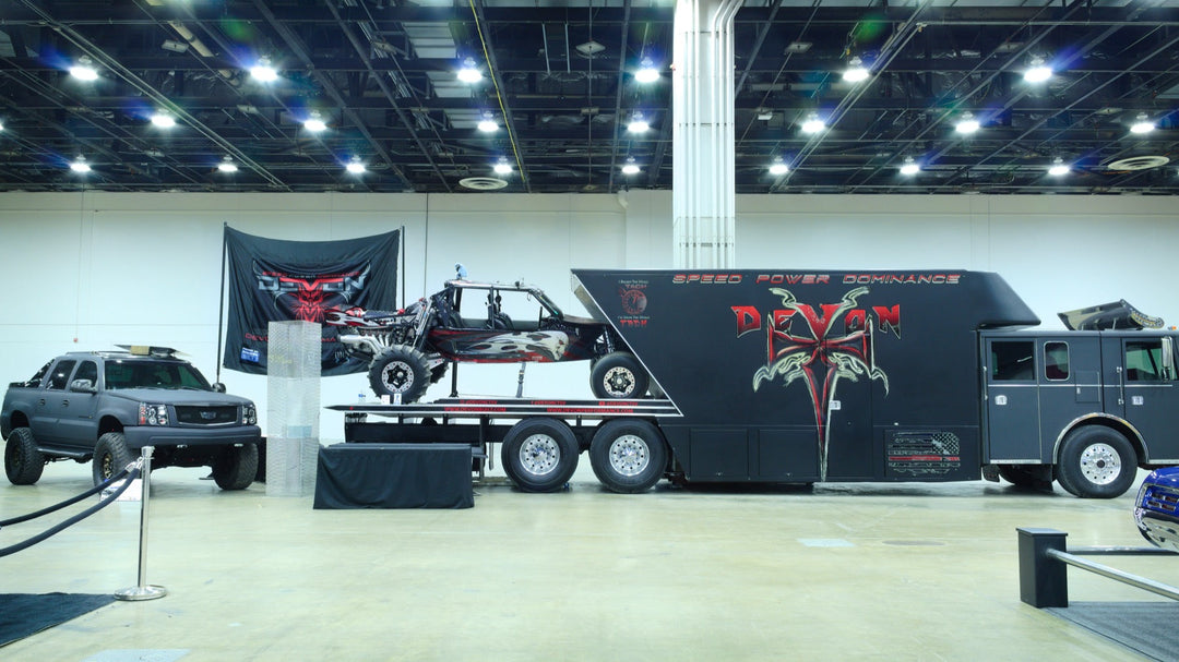 Devon Built show display with the custom firetruck hauler, off-road buggy, and custom truck