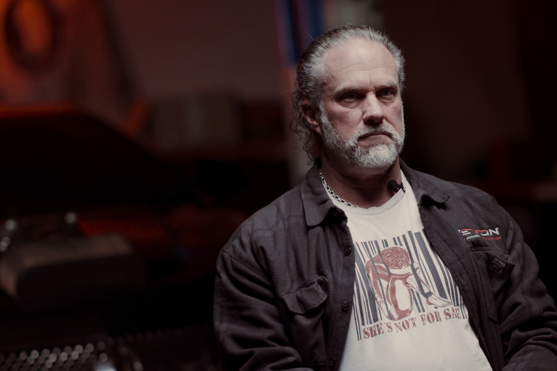 Devon Built founder in his garage wearing a faith graphic tee